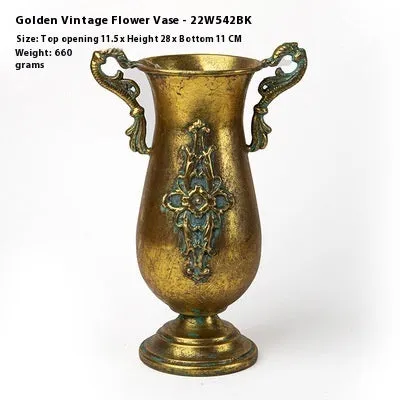 Metal decorative vase with black and gold finish, modern simplicity design on a tabletop