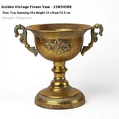 Metal decorative vase with black and gold finish, modern simplicity design on a tabletop