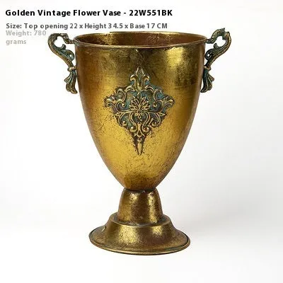 Metal decorative vase with black and gold finish, modern simplicity design on a tabletop