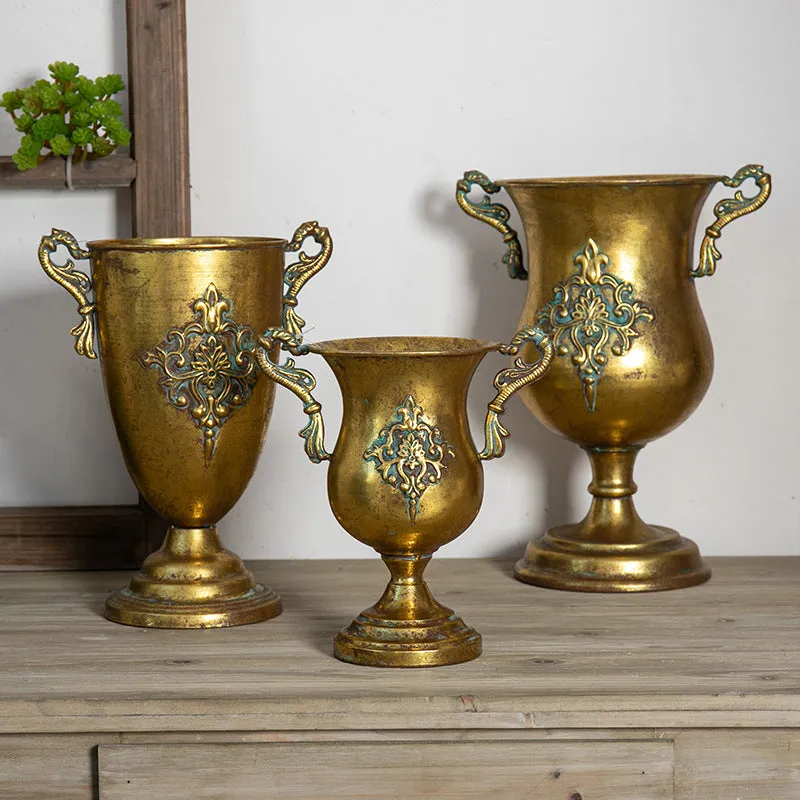 Metal decorative vase with black and gold finish, modern simplicity design on a tabletop