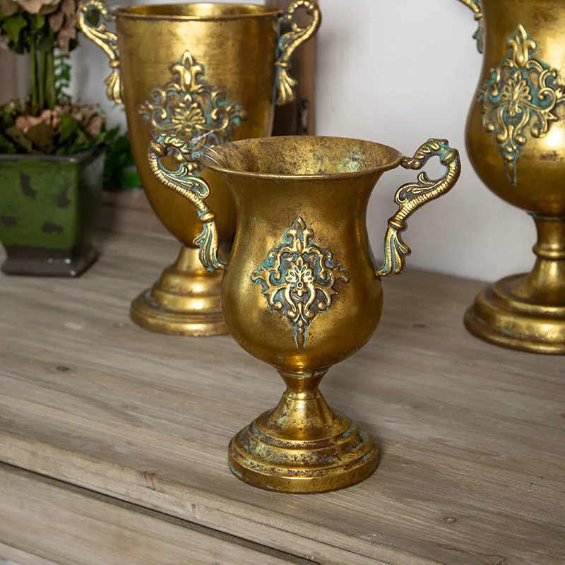 Metal decorative vase with black and gold finish, modern simplicity design on a tabletop