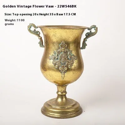Metal decorative vase with black and gold finish, modern simplicity design on a tabletop