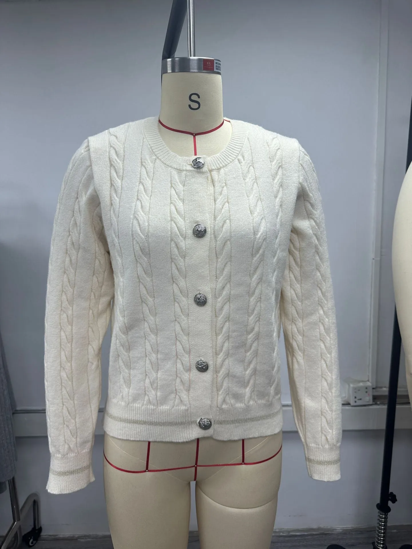Women's champagne round neck twisted knitted sweater coat cardigan with long sleeves, on a plain background