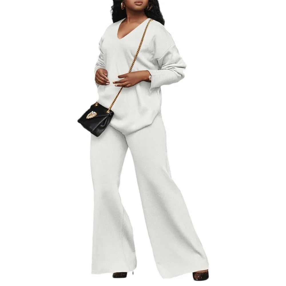 Women's brown thickened velvet two-piece suit with split sleeve top and trousers on a hanger.