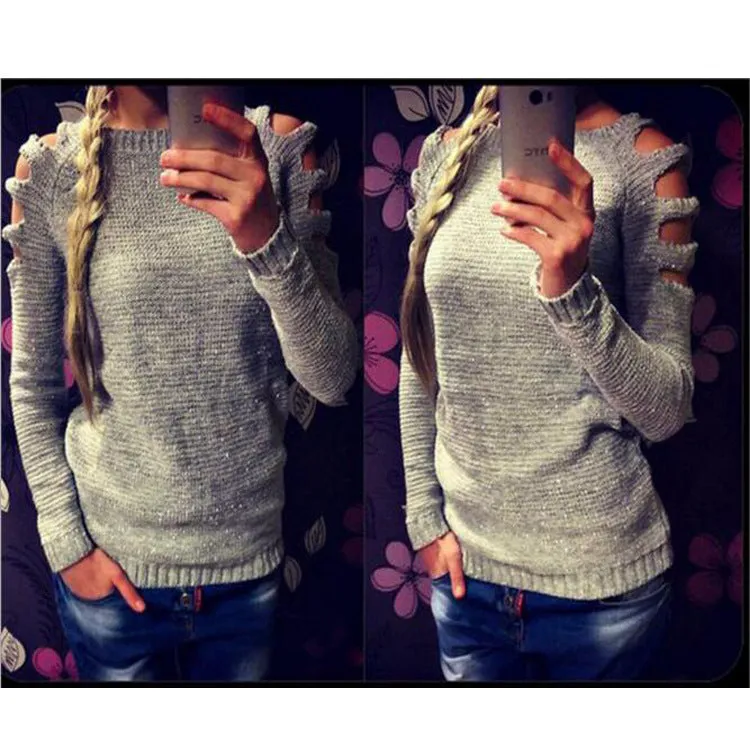White women's hollow-out knitted long sleeve shirt with round neck on a hanger.