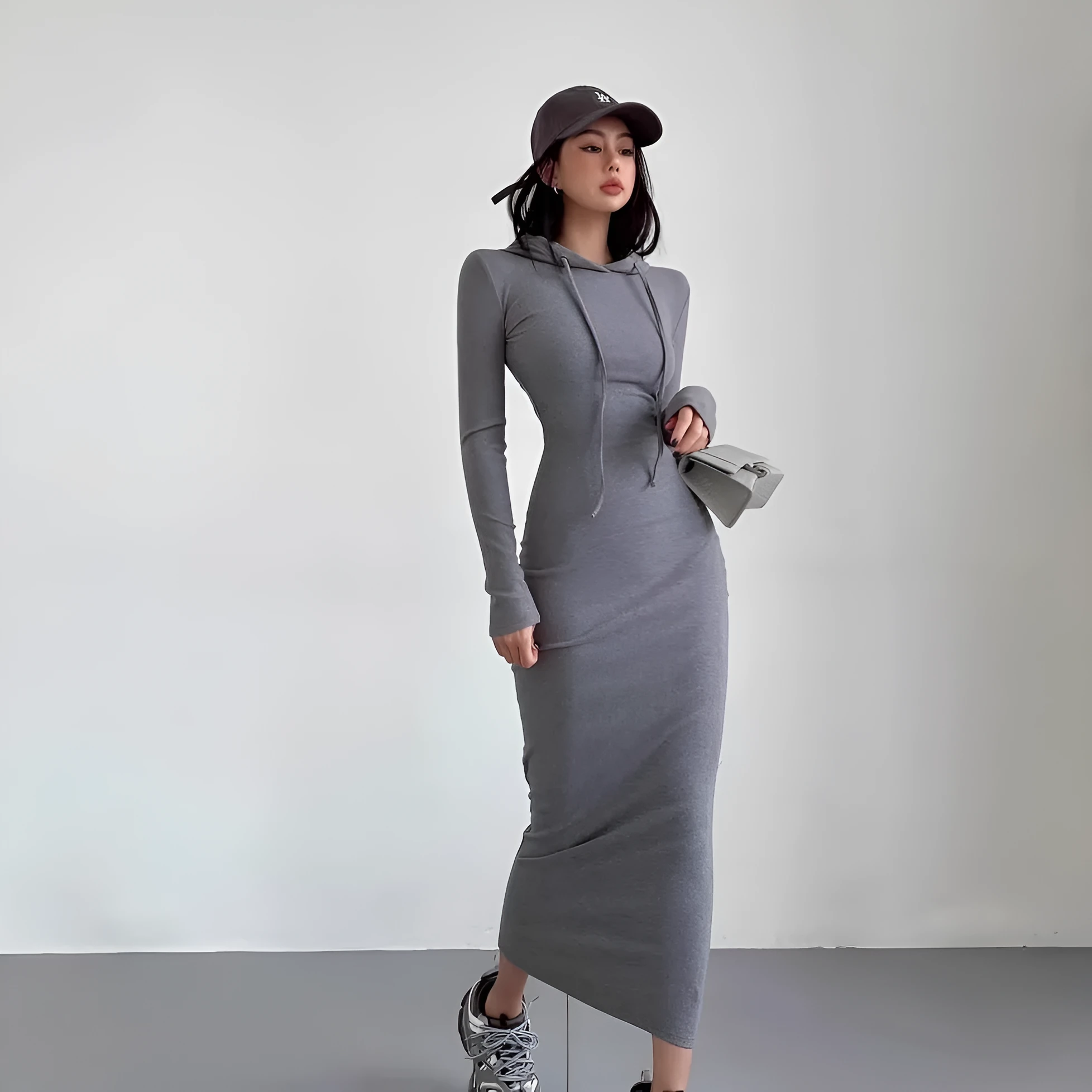 Women's light gray hooded sheath dress with long sleeves and a high waist on a hanger
