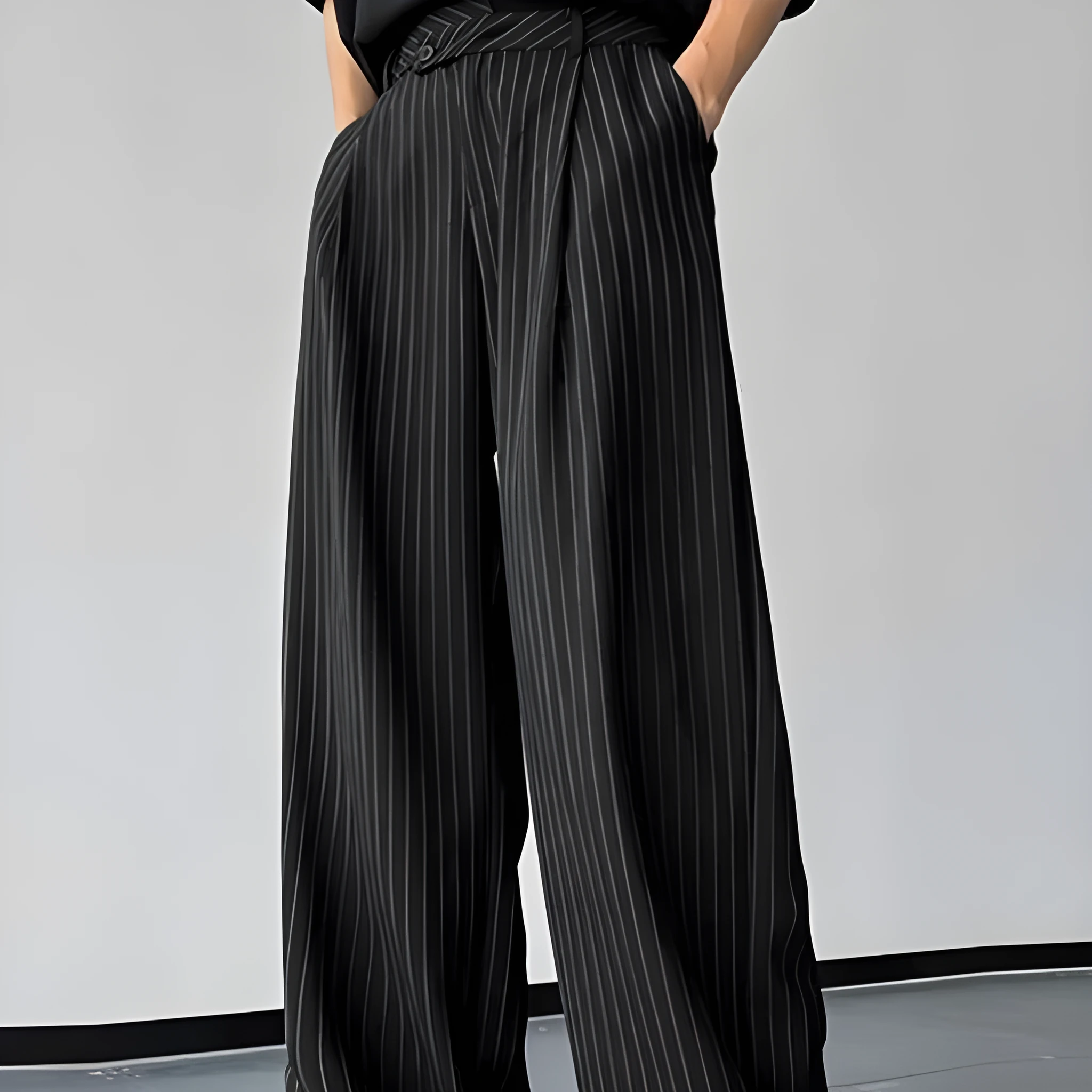 Men's black vertical striped pleated casual trousers showing elastic fabric detail