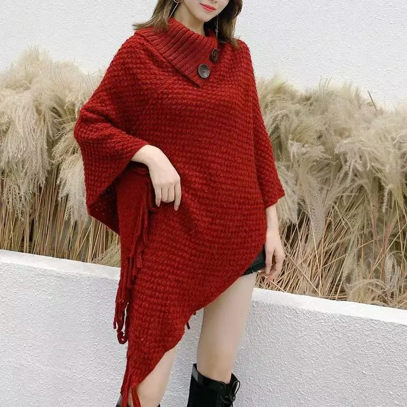 Women's plush triangle shawl cape in a cashmere blend with tassel detailing, shown in wine red.