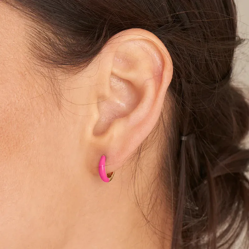 A pair of oval glossy light green epoxy dome earrings on a silver-toned U-shaped geometric wire, against a neutral background.