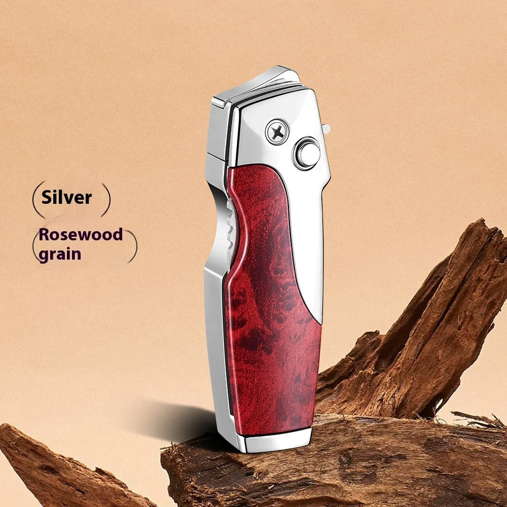 Closed metal folding lighter with integrated knife in a carbon fibre finish, showing the safety lock and refill valve.