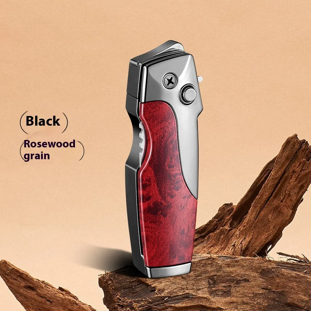 Closed metal folding lighter with integrated knife in a carbon fibre finish, showing the safety lock and refill valve.