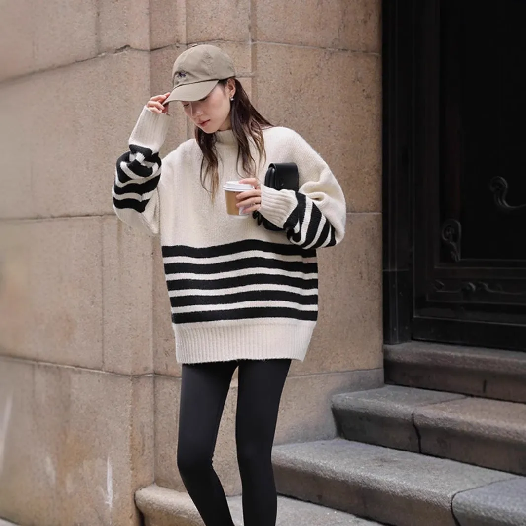 Beige loose maternity sweater with stand collar and long sleeves on a plain background