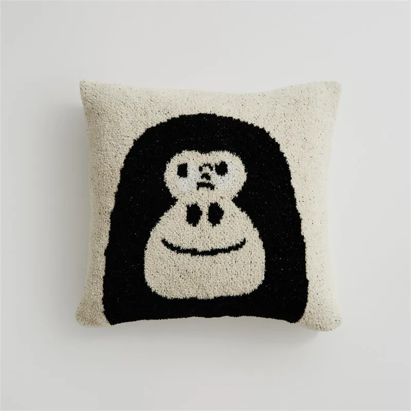 Cartoon anime knitted velvet pillowcase in black big face design on a bed