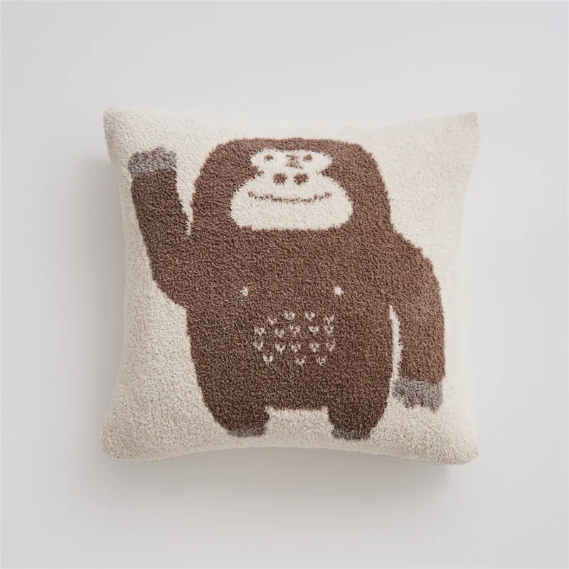 Cartoon anime knitted velvet pillowcase in black big face design on a bed