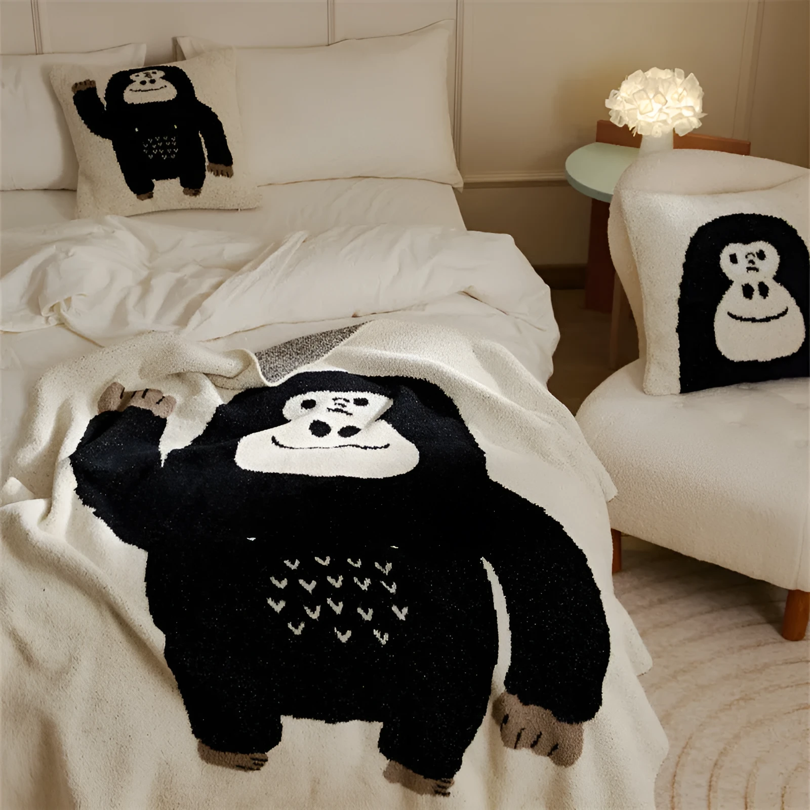 Cartoon anime knitted velvet pillowcase in black big face design on a bed