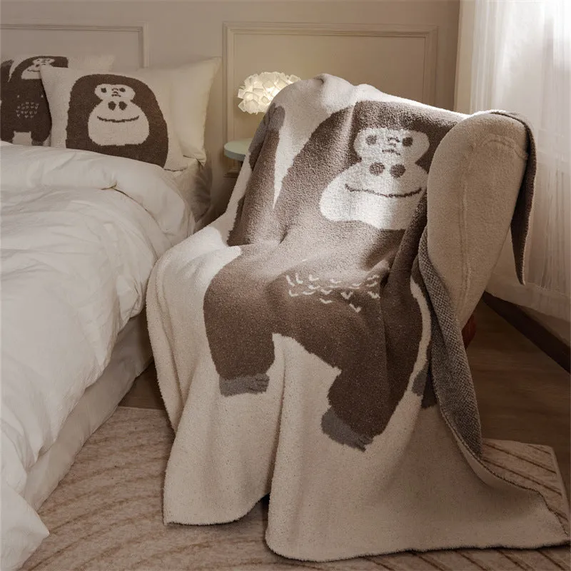 Cartoon anime knitted velvet pillowcase in black big face design on a bed