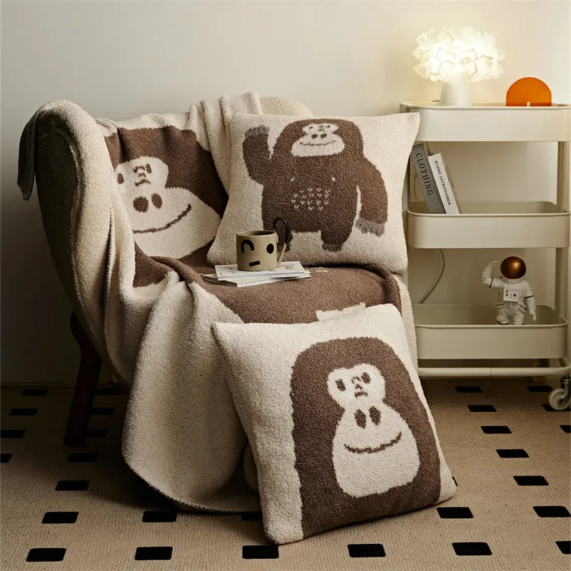 Cartoon anime knitted velvet pillowcase in black big face design on a bed