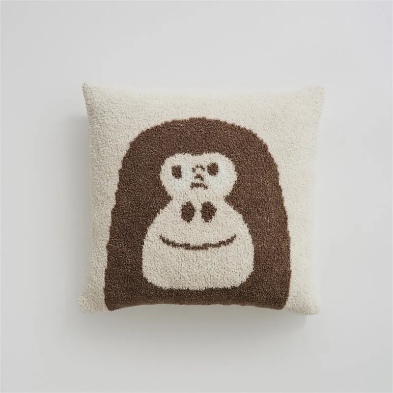 Cartoon anime knitted velvet pillowcase in black big face design on a bed