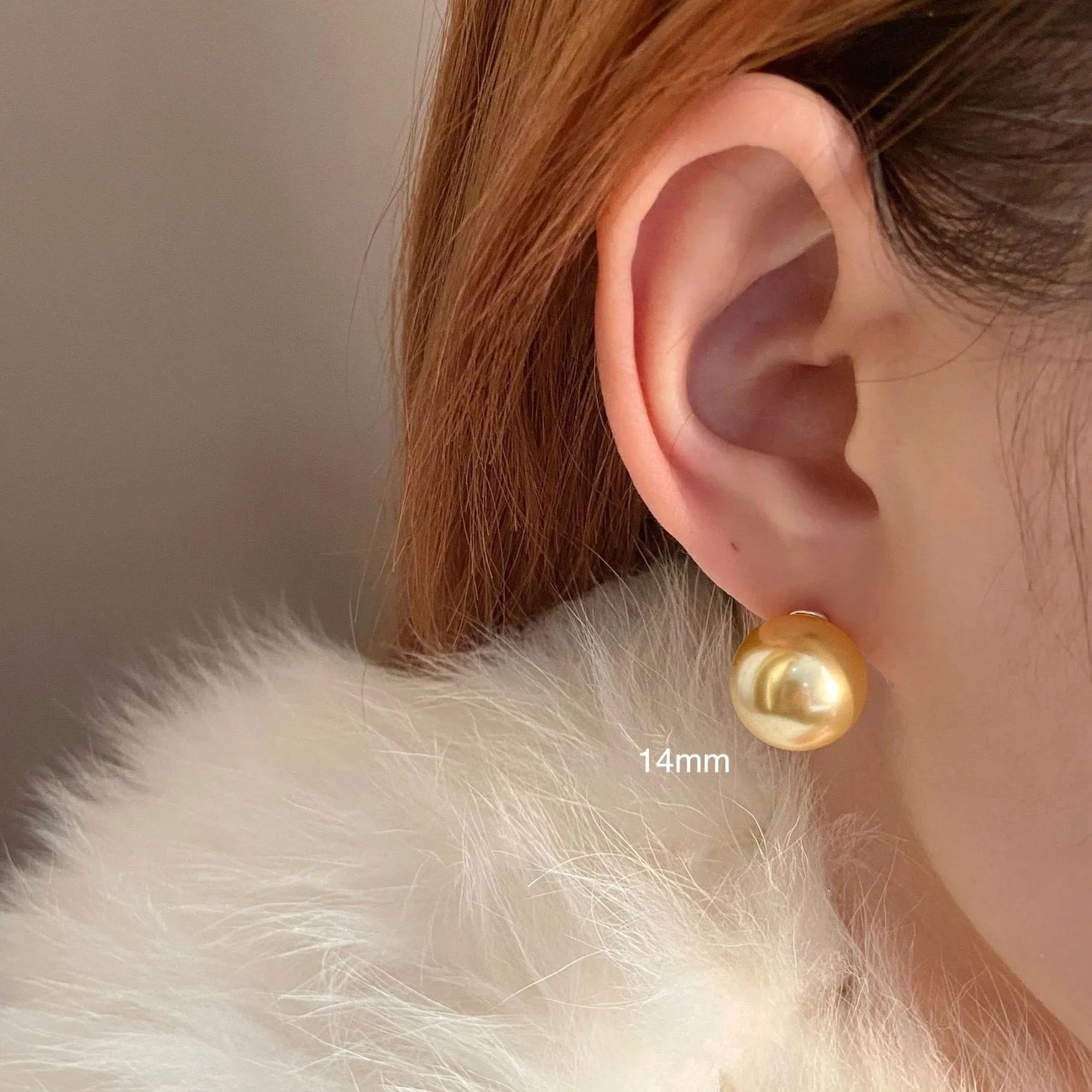 A pair of large pearl stud earrings with a geometric silver setting and an eight-pointed star detail on a white background.