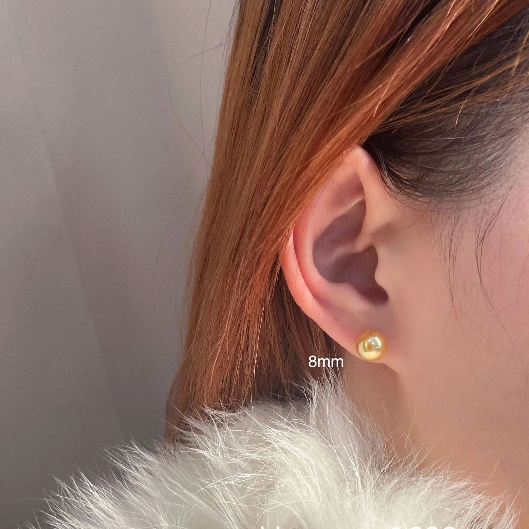 A pair of large pearl stud earrings with a geometric silver setting and an eight-pointed star detail on a white background.