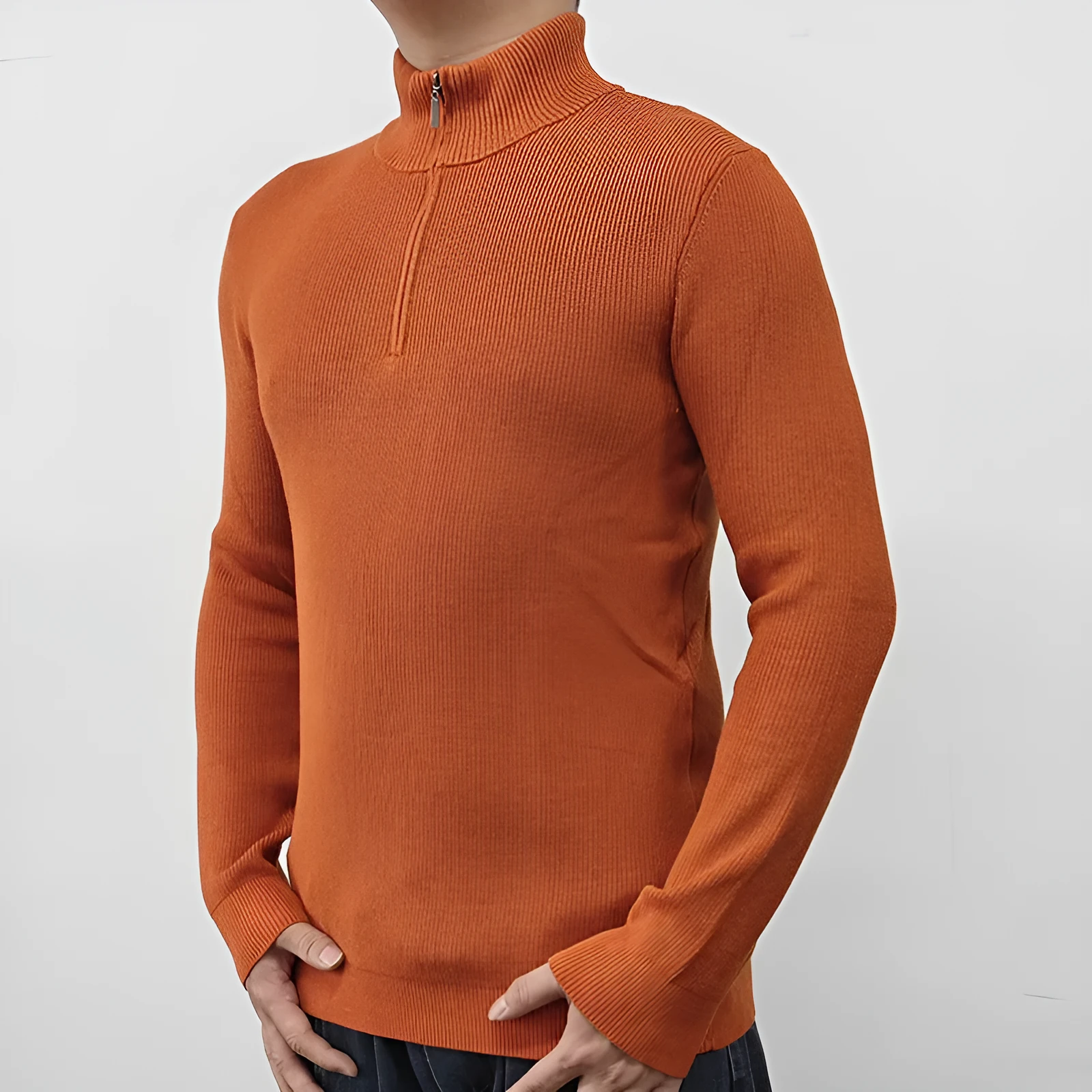 Men's black half-turtleneck zip sweater on a hanger, showing long sleeves and zip front detail.