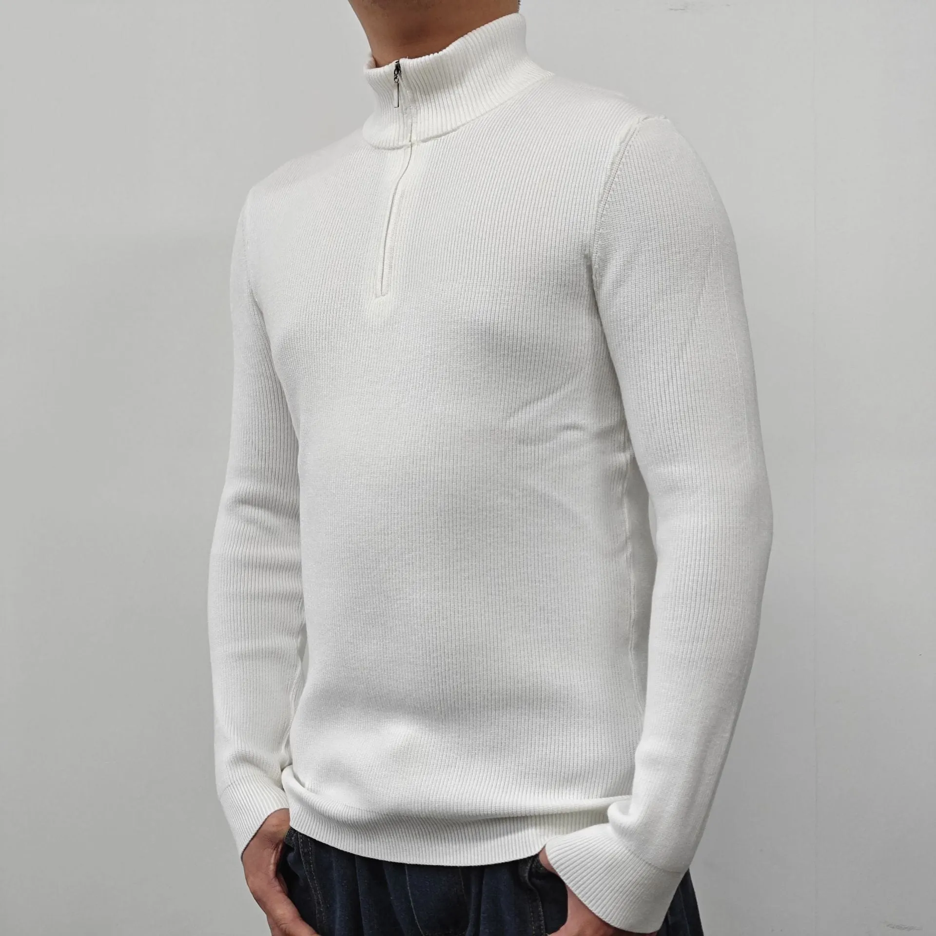 Men's black half-turtleneck zip sweater on a hanger, showing long sleeves and zip front detail.