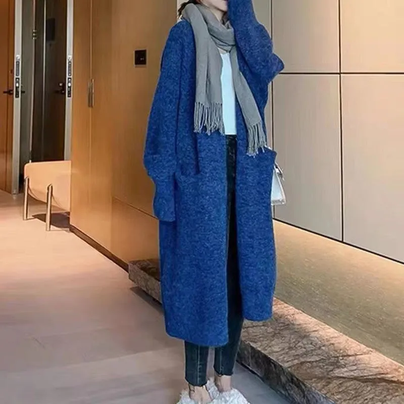 Women loose mid-length knitted cardigan in solid colour with long sleeves and pockets.