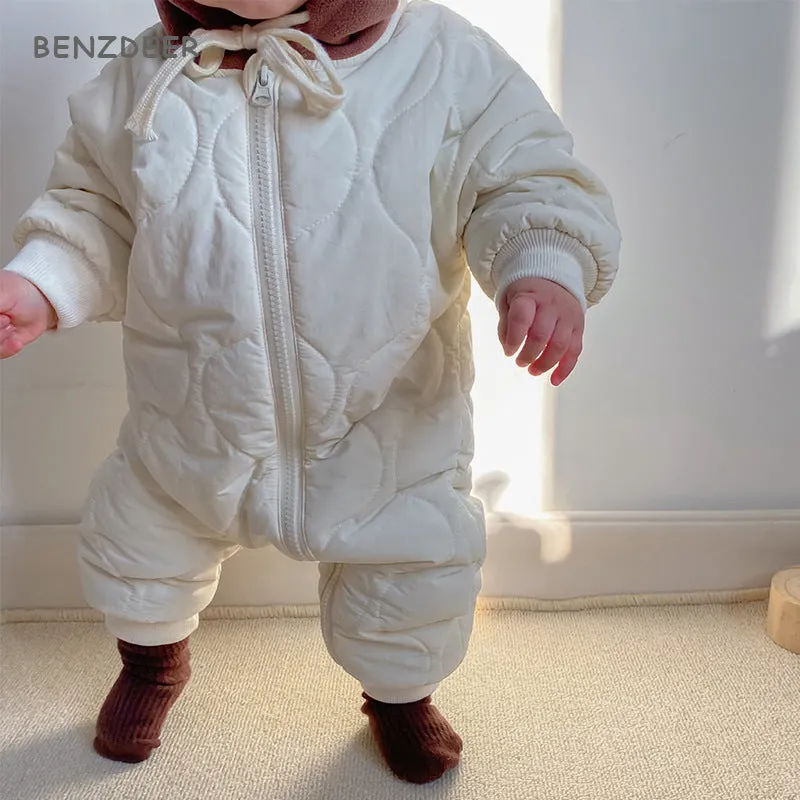 Baby padded quilted cotton kumpsuit in beige with attached hat and long sleeves, shown on a white background