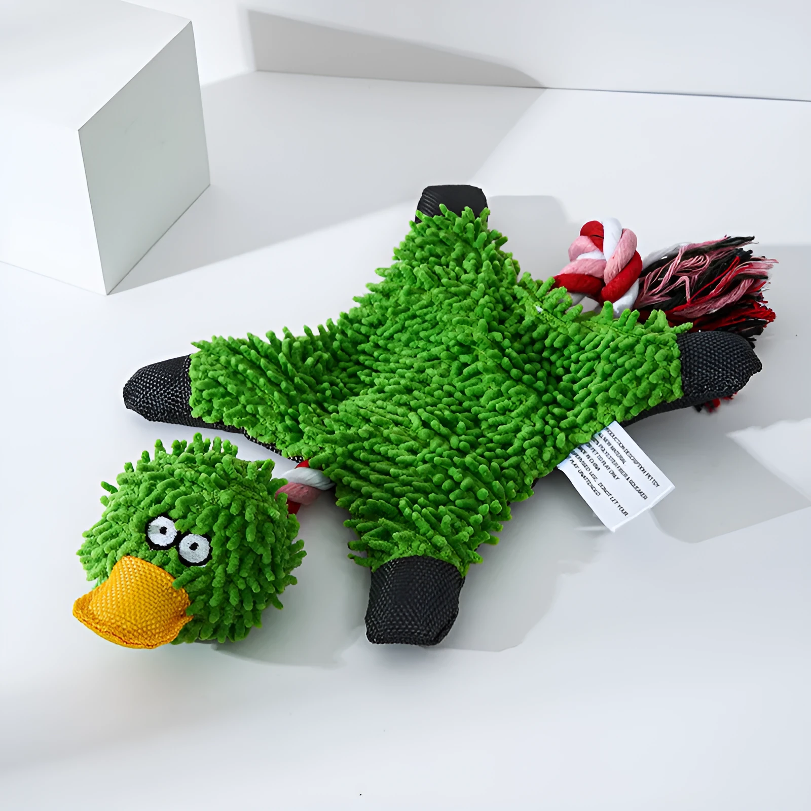 Mop plush duck dog toy in green on neutral background