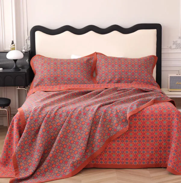 Three-piece cotton gauze bed blanket set with floral pattern showing blanket and two pillowcases
