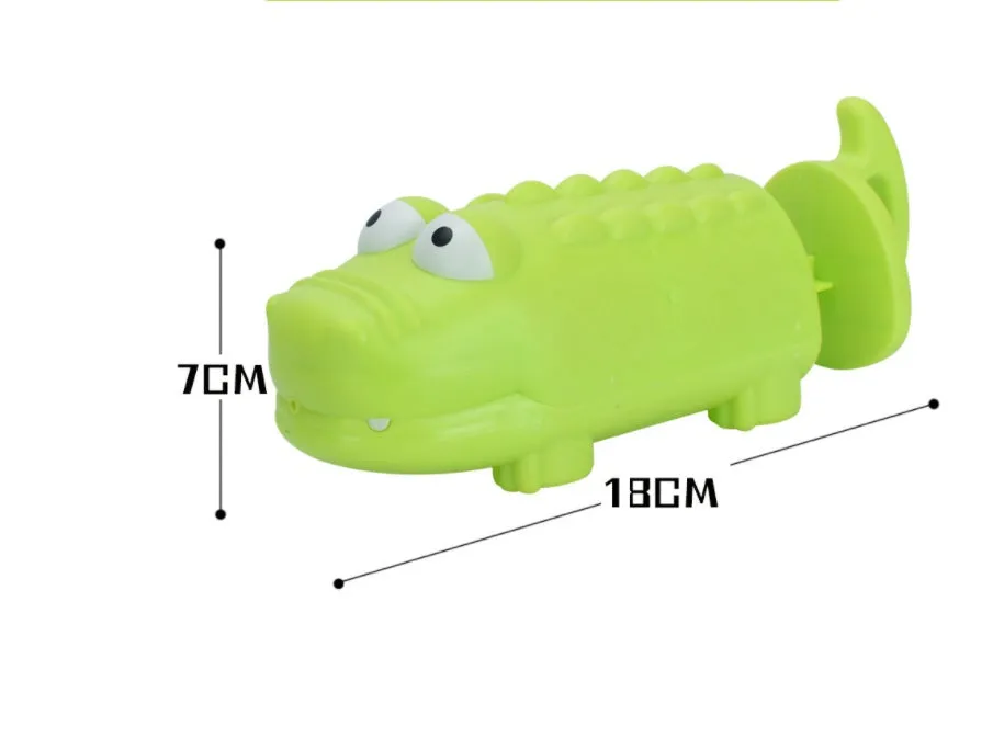 Children's plastic dinosaur water gun bath toy in blue, green, orange, pink, or sky blue on white background