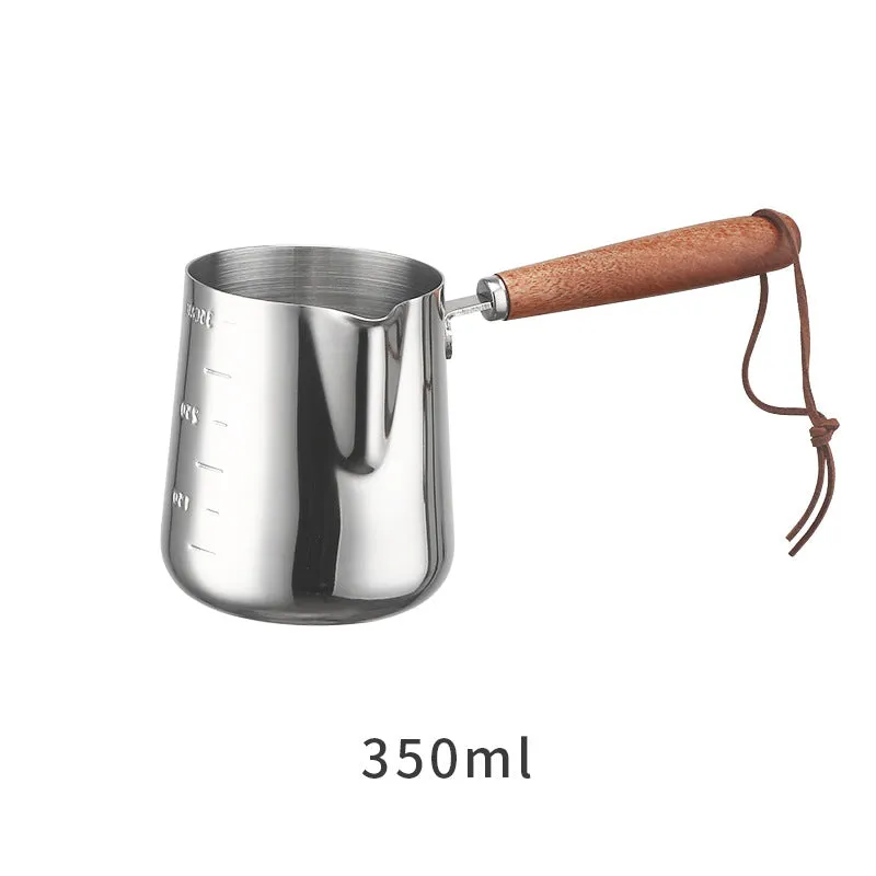 Stainless steel coffee milk jug with a scaled wooden handle shown in a simple solid colour.