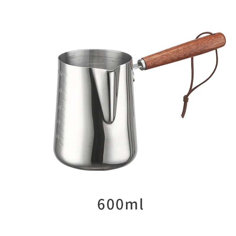 Stainless steel coffee milk jug with a scaled wooden handle shown in a simple solid colour.