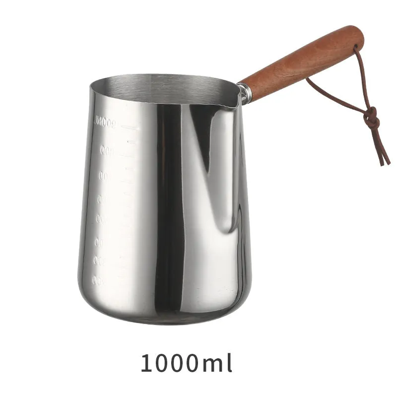 Stainless steel coffee milk jug with a scaled wooden handle shown in a simple solid colour.