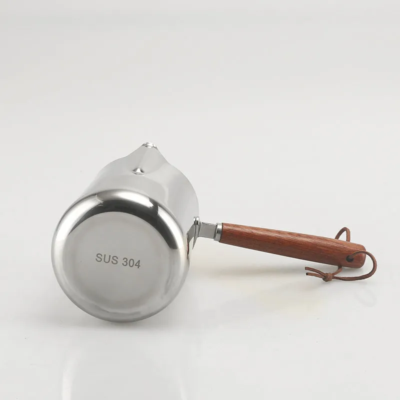 Stainless steel coffee milk jug with a scaled wooden handle shown in a simple solid colour.
