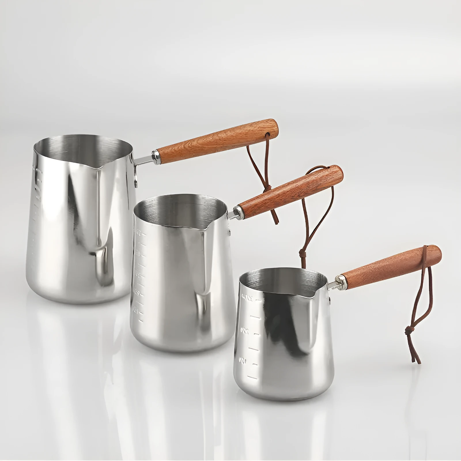 Stainless steel coffee milk jug with a scaled wooden handle shown in a simple solid colour.