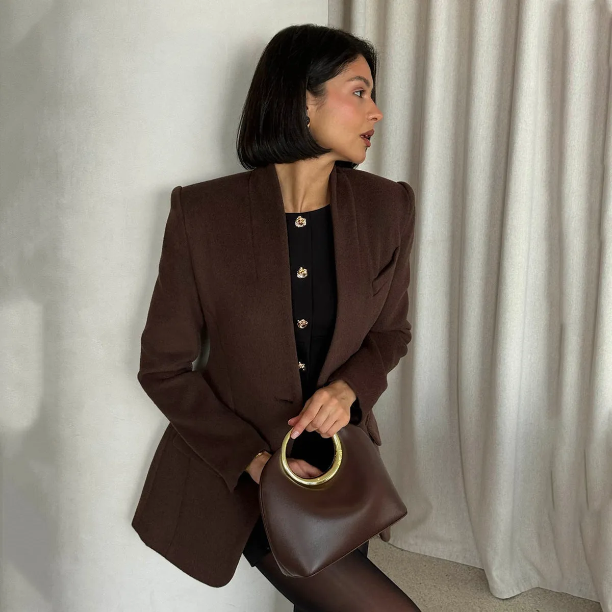 Single button slim fit solid brown polyester fibre suit coat on display
