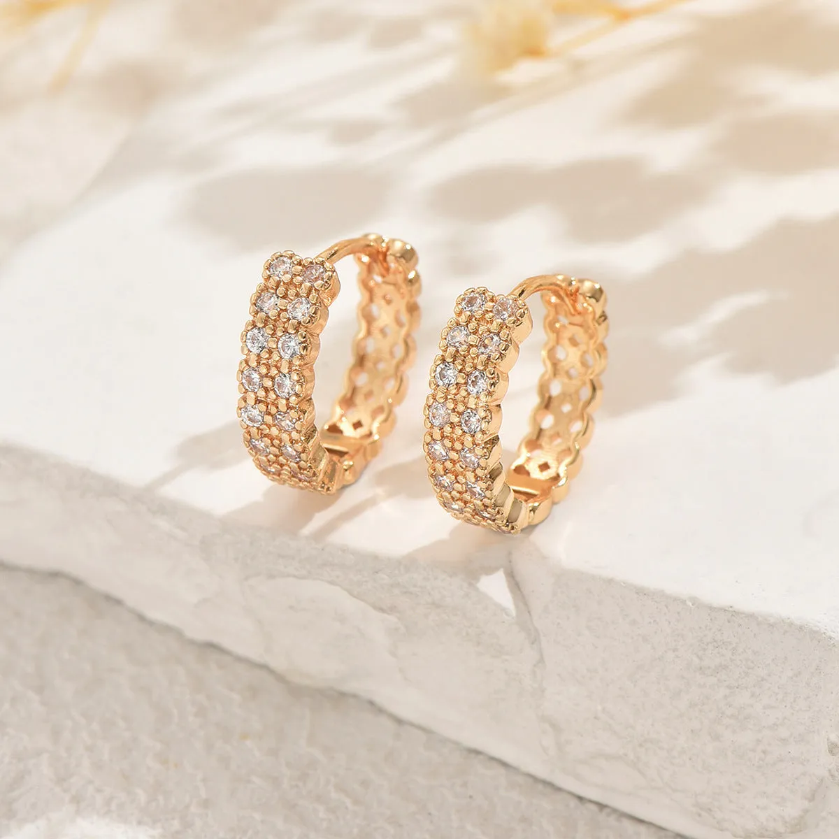 A pair of copper geometry pattern ear studs with round, dot and ring designs in colour DE20288.