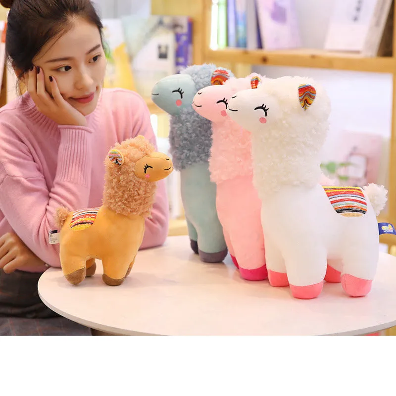 Alpaca llama plush toy in white standing on a surface