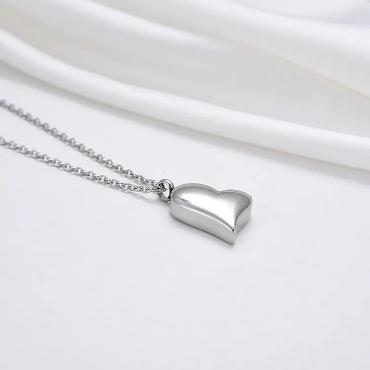 Silver curved peach heart stainless steel pendant necklace on display