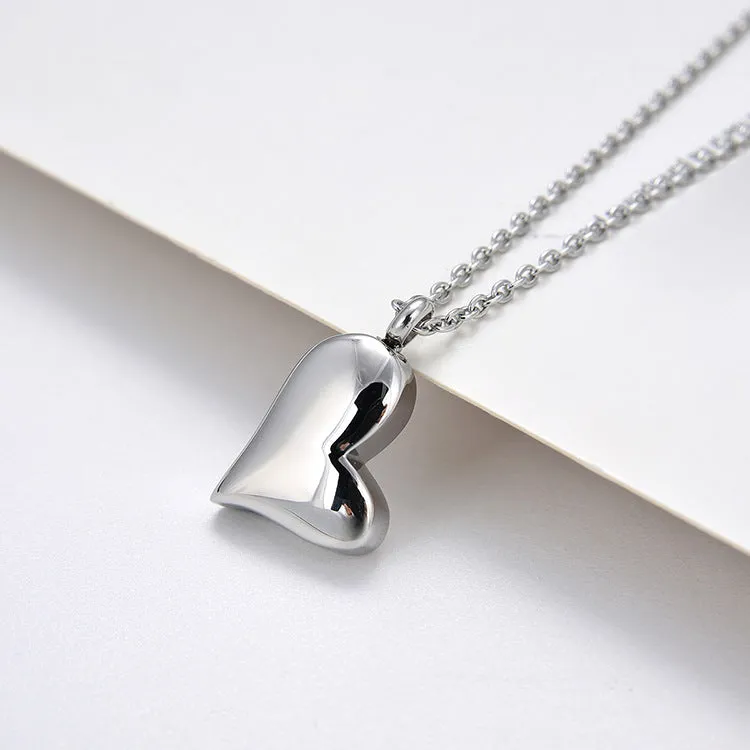 Silver curved peach heart stainless steel pendant necklace on display
