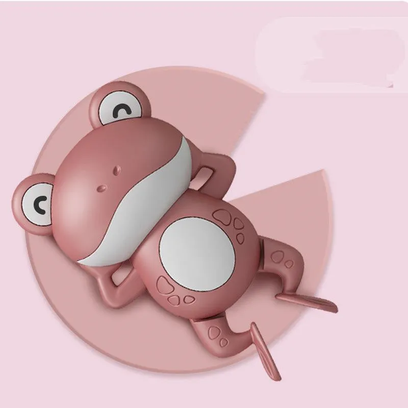 Little Frog clockwork floating bath toy in Coral Red on water surface