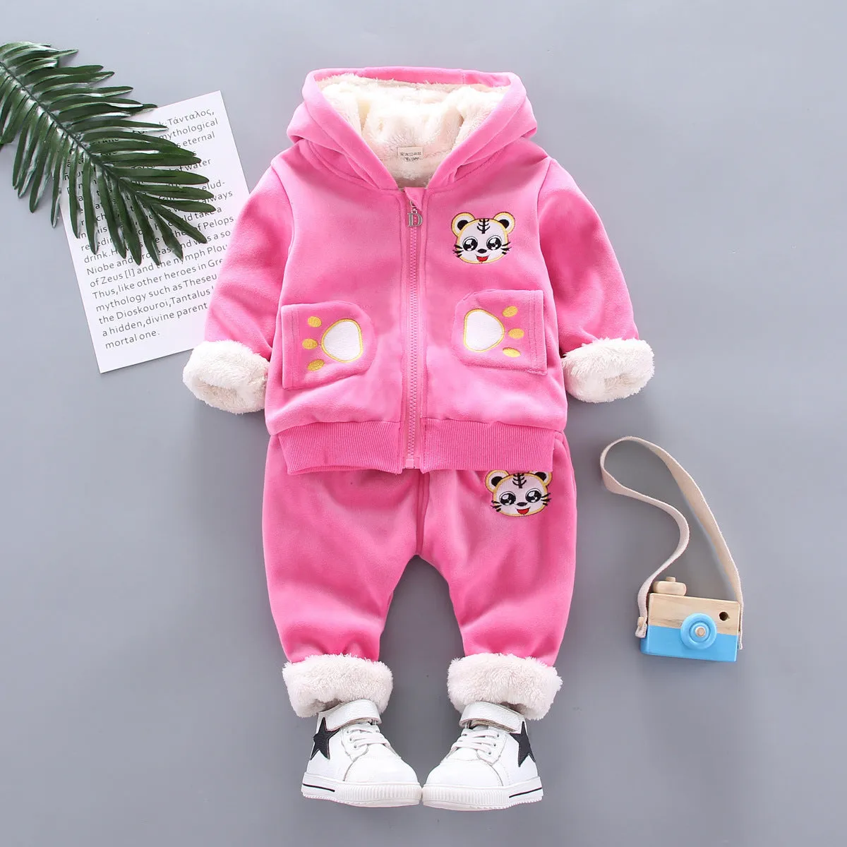 Child wearing a long sleeve golden mink fleece pyjama set with cartoon animal pattern in navy blue for winter