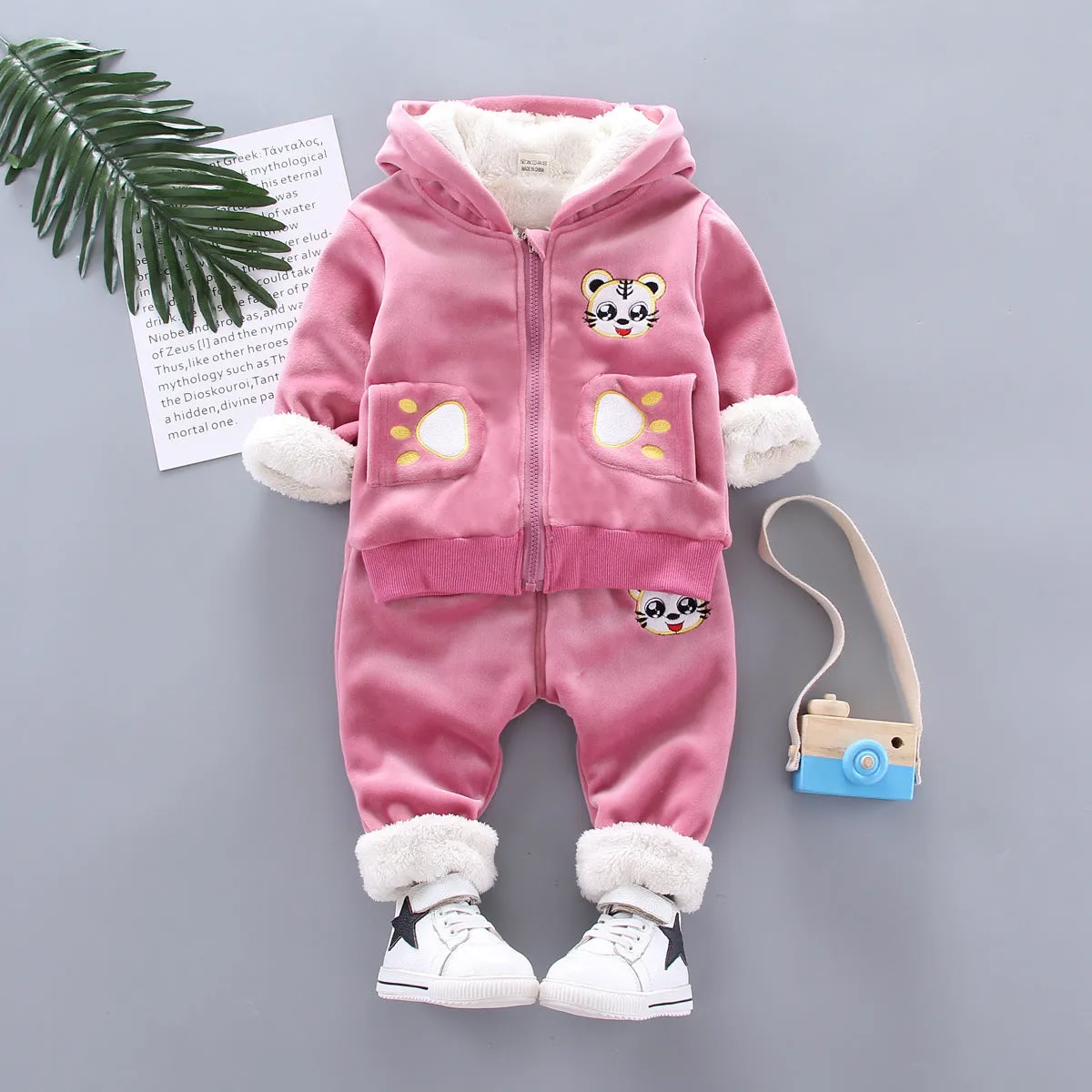 Child wearing a long sleeve golden mink fleece pyjama set with cartoon animal pattern in navy blue for winter