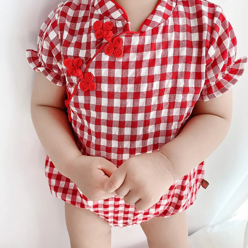 Red cotton baby cheongsam jumpsuit with short sleeves and triangle climbing design on white background