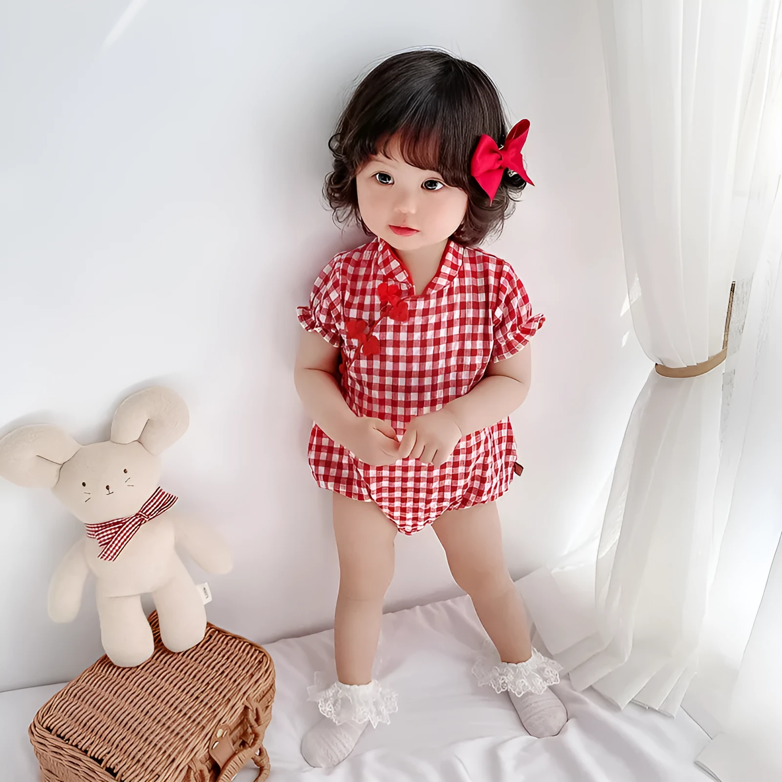 Red cotton baby cheongsam jumpsuit with short sleeves and triangle climbing design on white background
