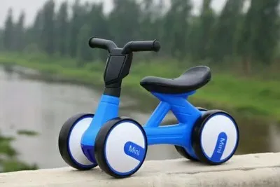 Plastic no-pedal baby balance bike with three wheels, carbon steel frame, EVA foam tyres, and artificial PU leather seat