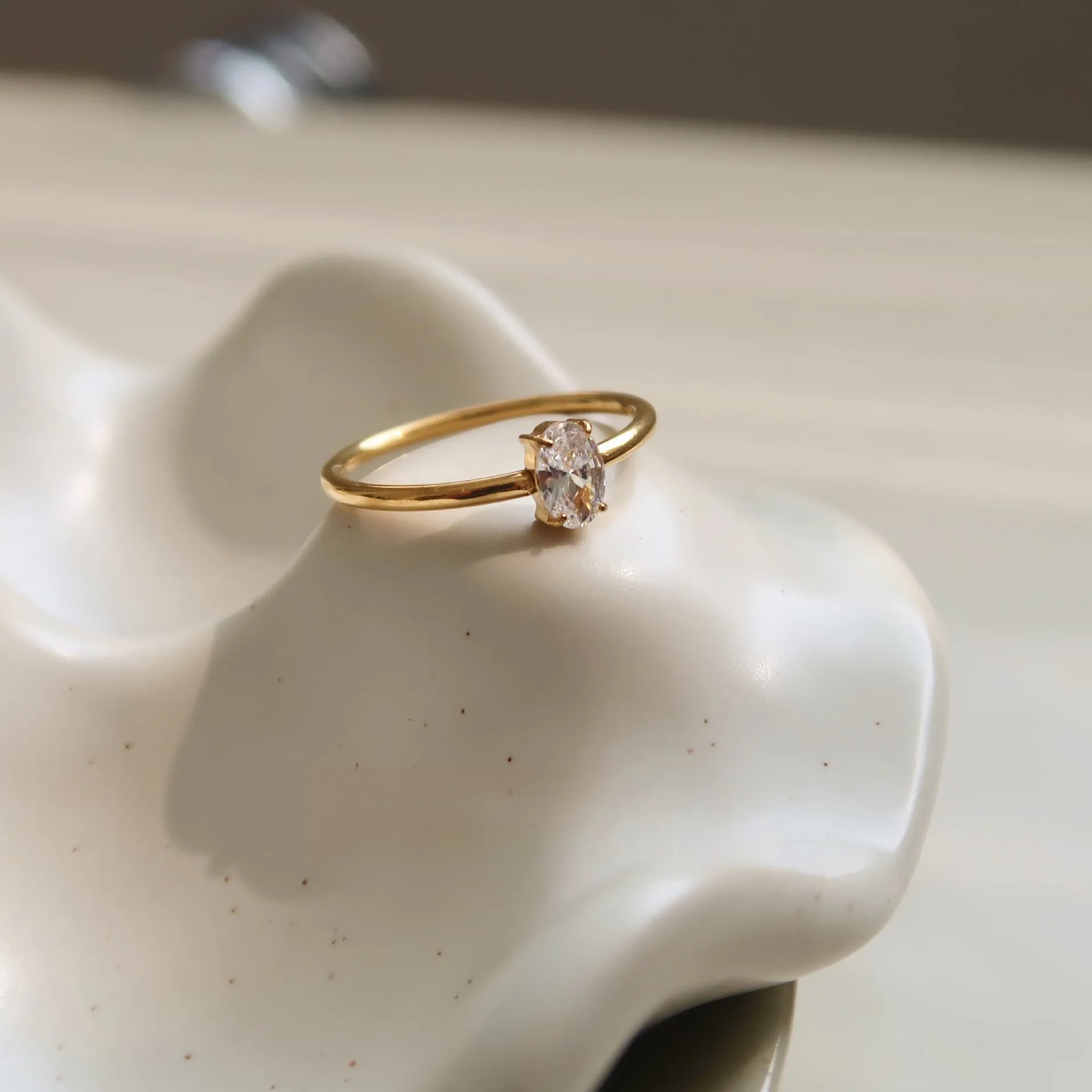 Golden love heart stainless steel ring showing heart shape design on female hand