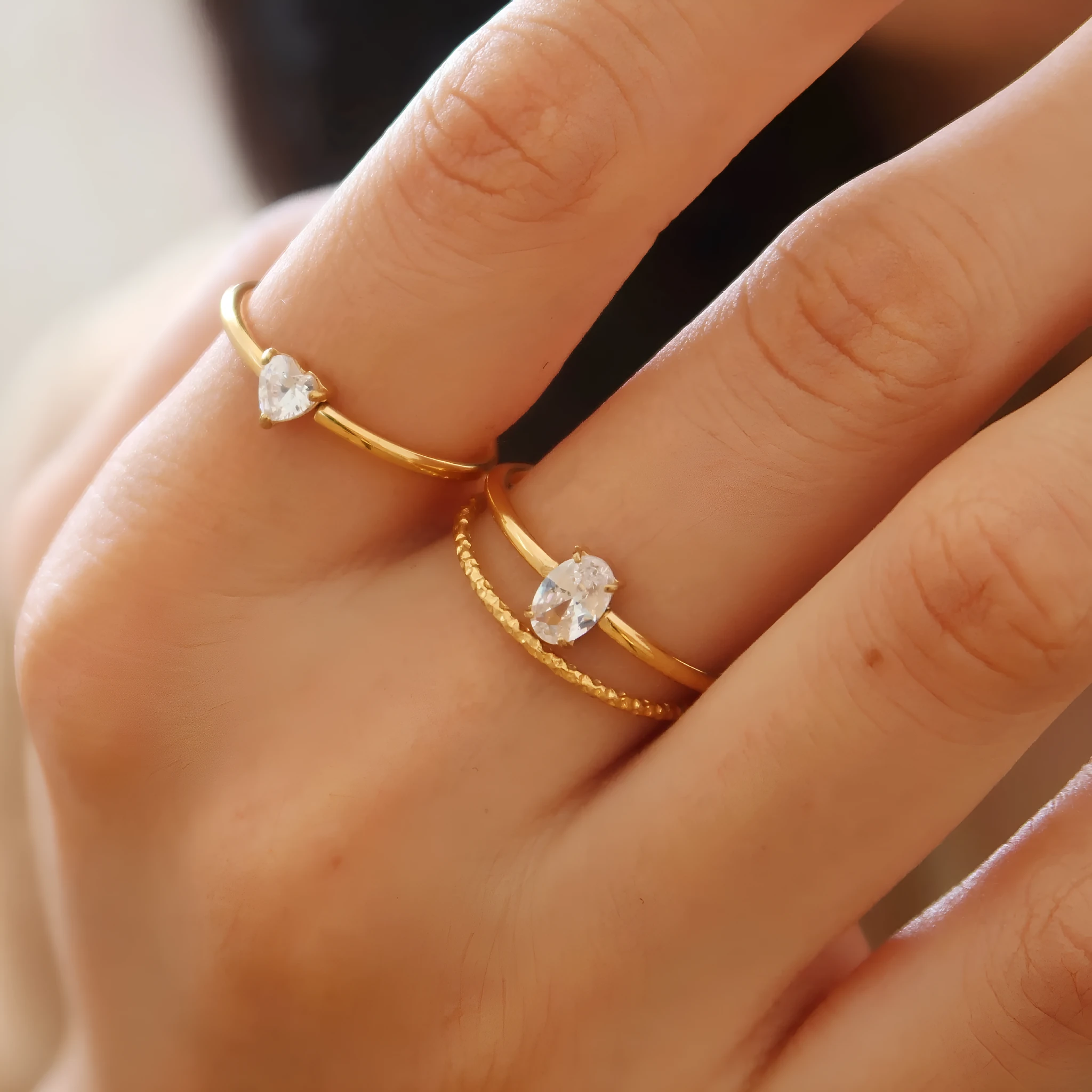Golden love heart stainless steel ring showing heart shape design on female hand
