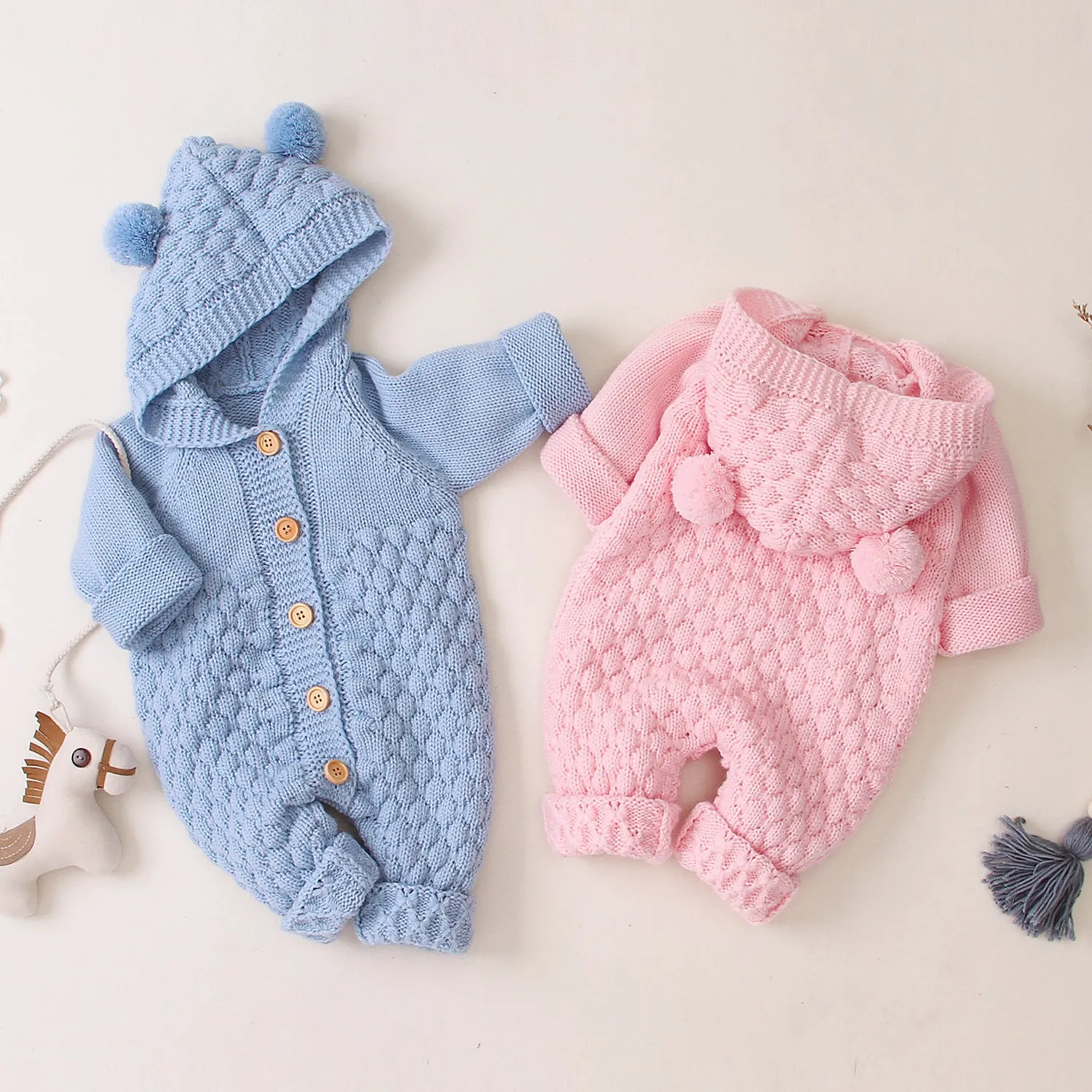 Baby knitted jumpsuit in blue, full-length with button front and hand flaps